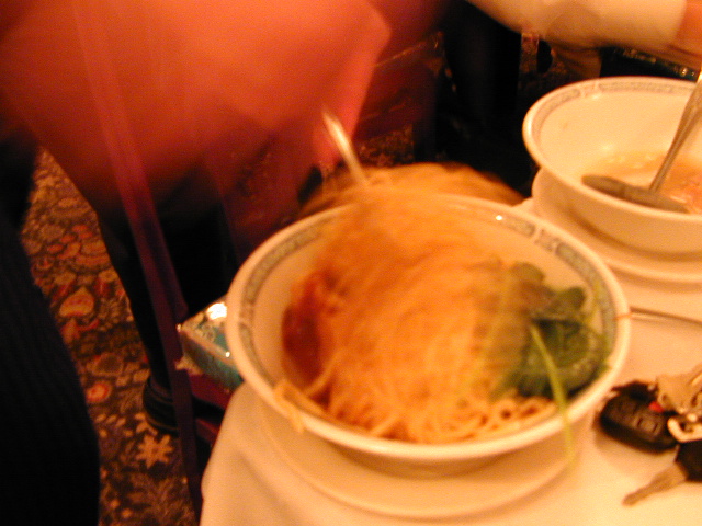 Spicy Noodles 2: The waiter is mixing up the spicy noodles, but the shutter speed is so slow he's just a blur.